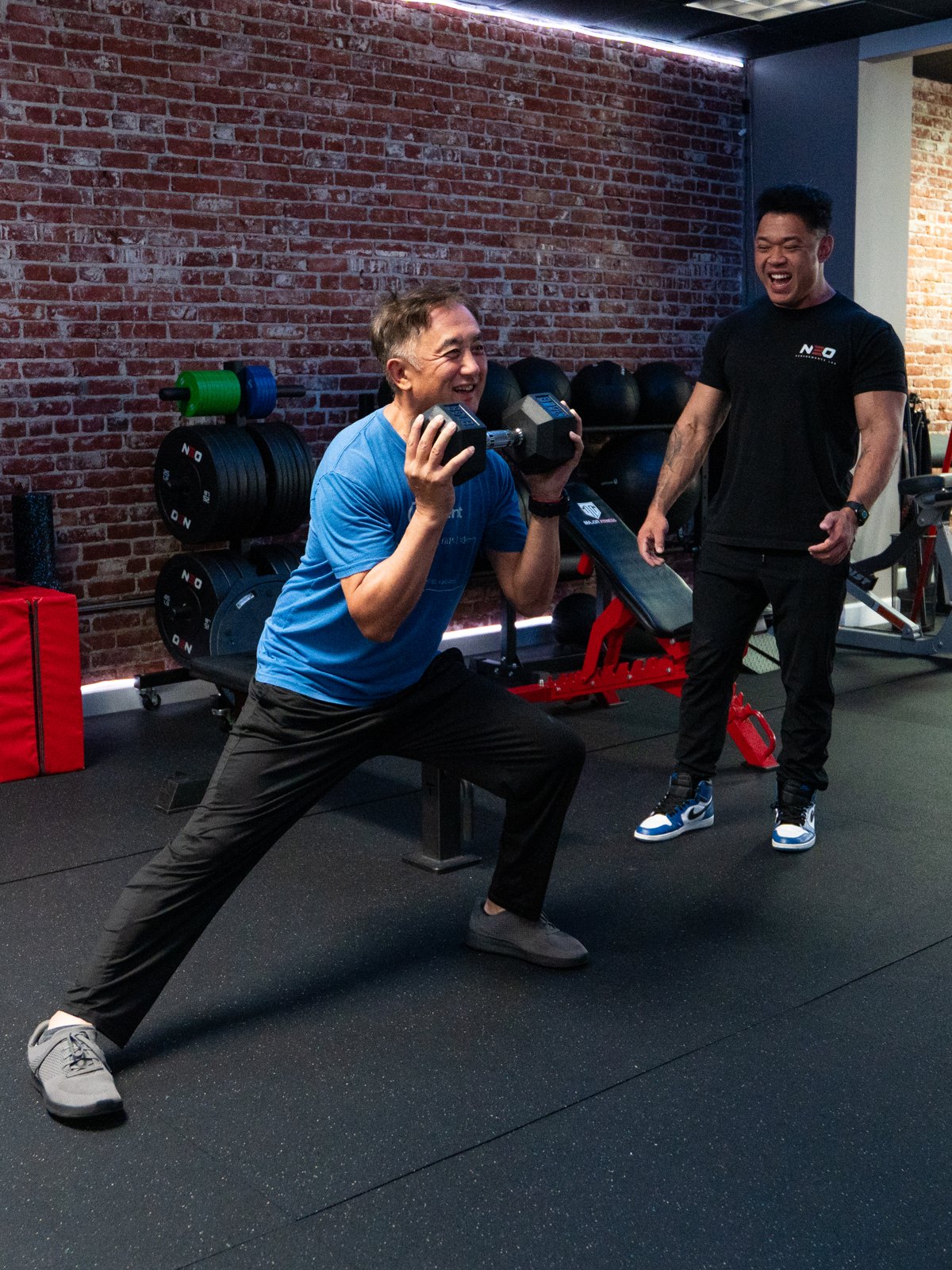 Dr. Kelvin Lee coaching James through a side lunge
